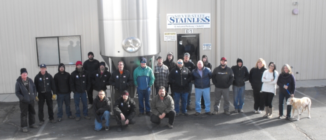 Silver State Stainless staff standing outside their facility with a golden lab dog